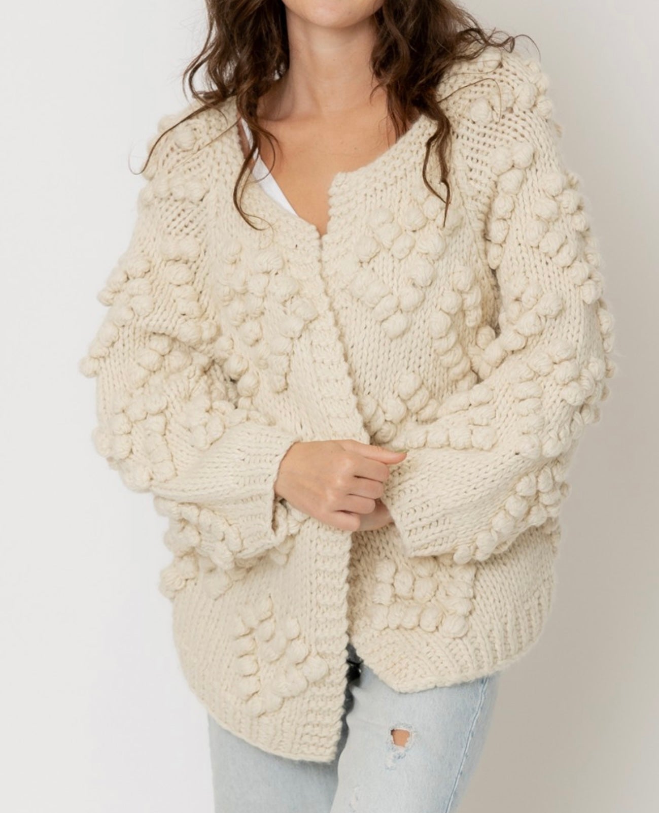 Cream cardigan sweater with pom pom details in heart shape