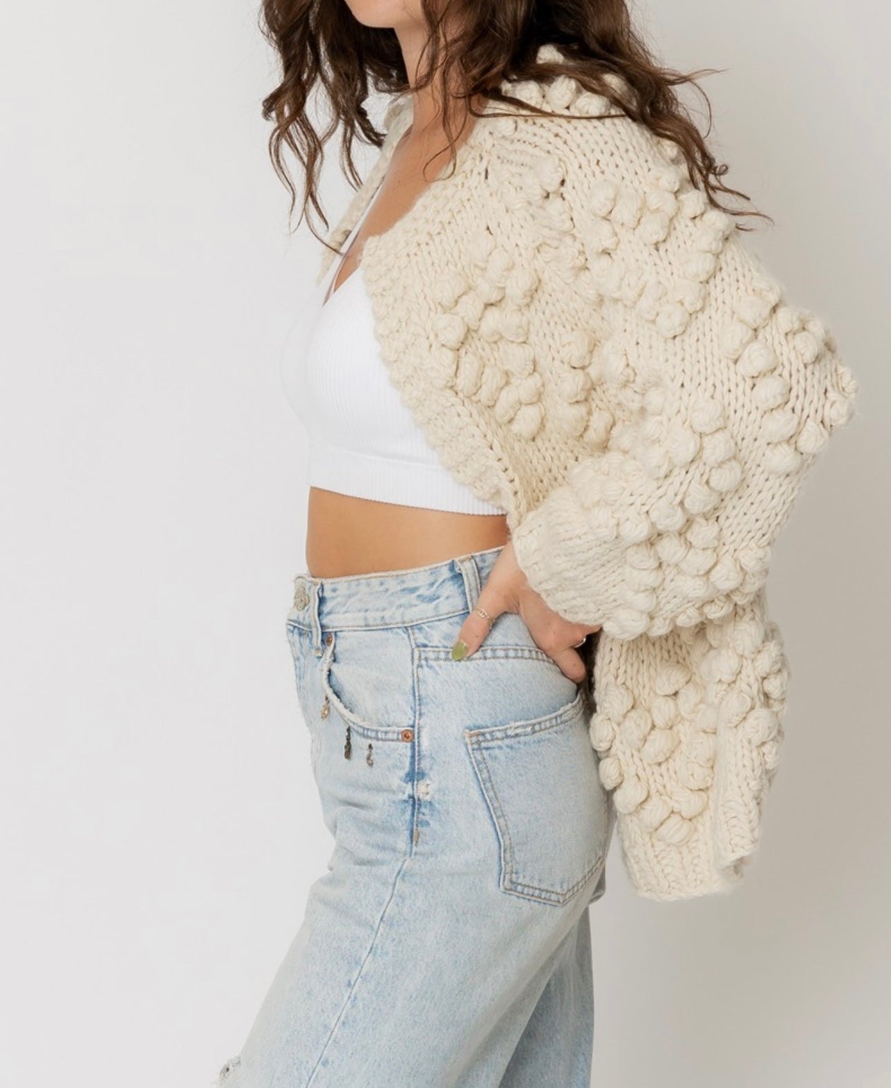 Cream cardigan sweater with pom pom details in heart shape