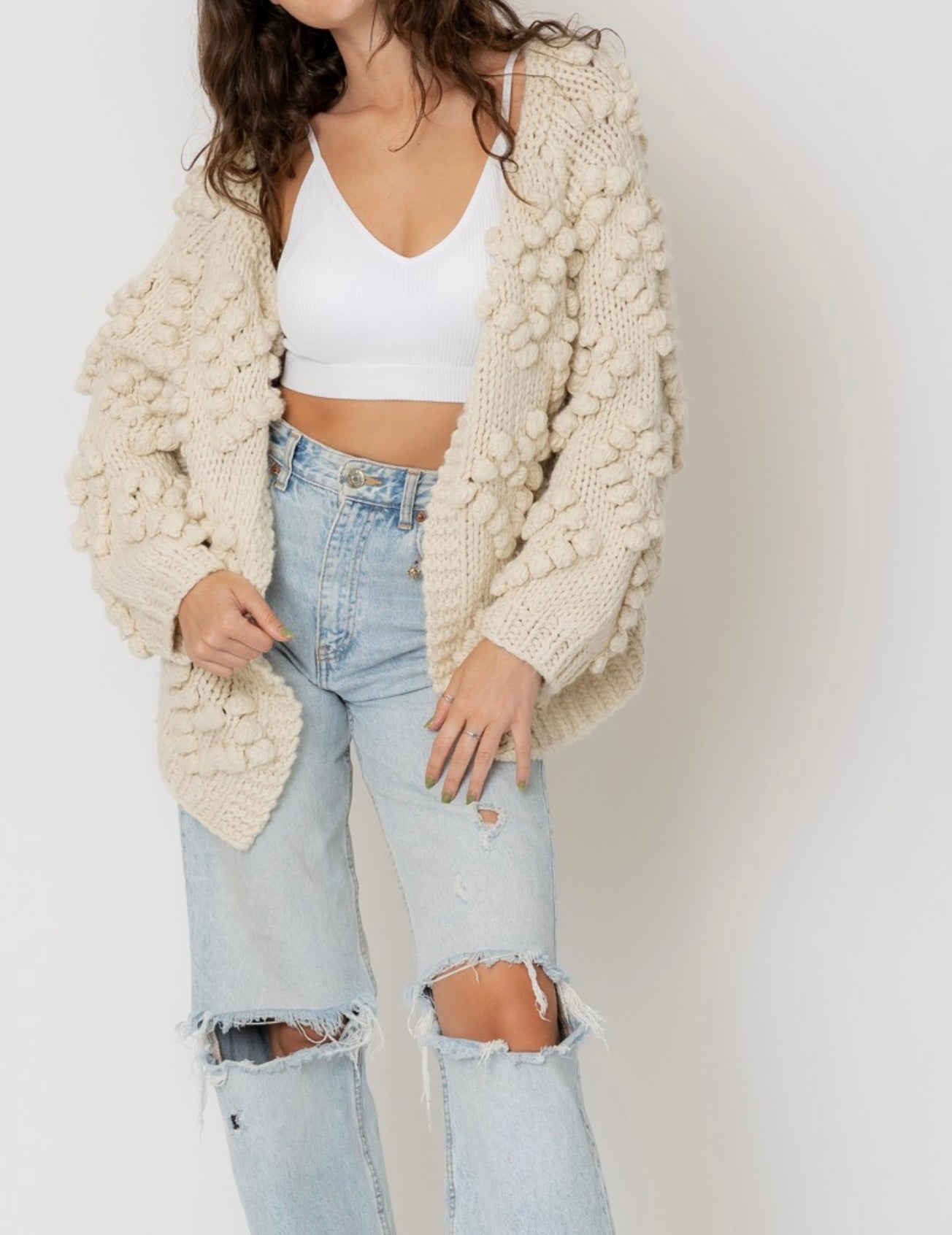 Cream cardigan sweater with pom pom details in heart shape